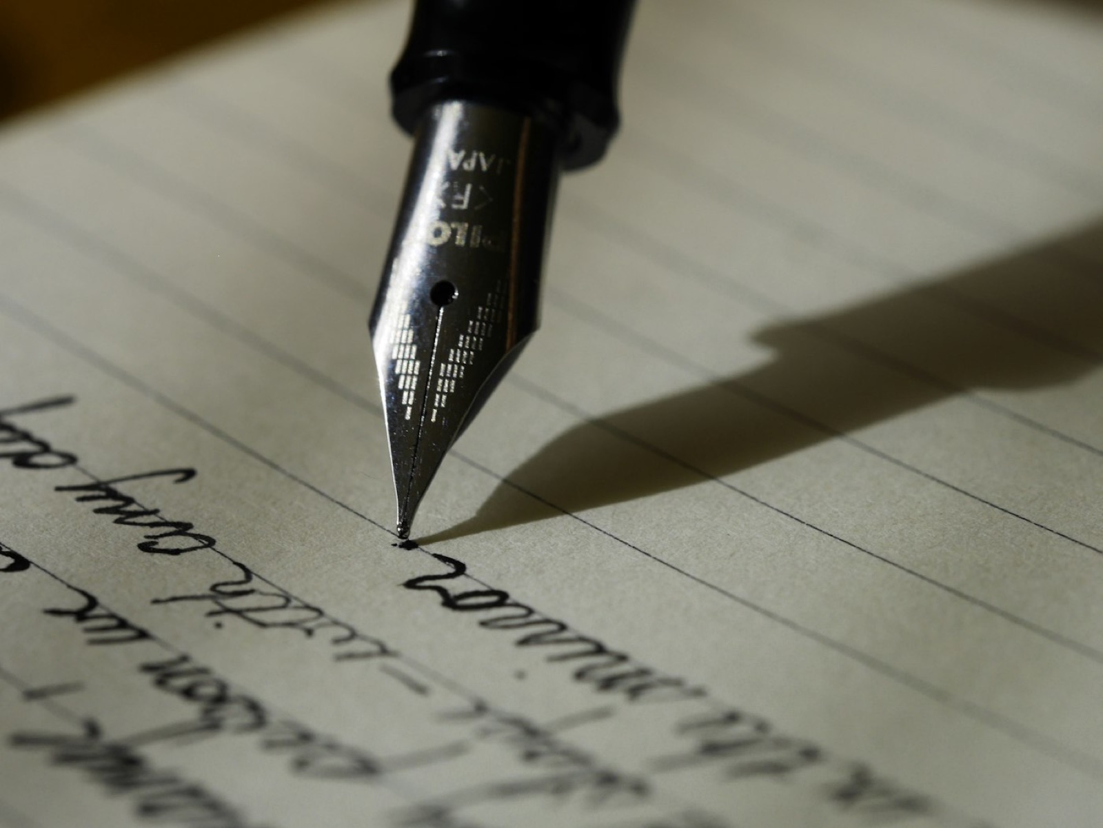Hands writing a customised plan in a notebook
